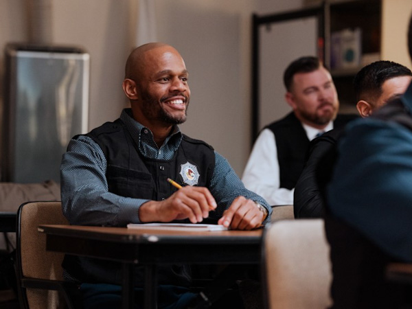 A man sitting at a desk in a training class