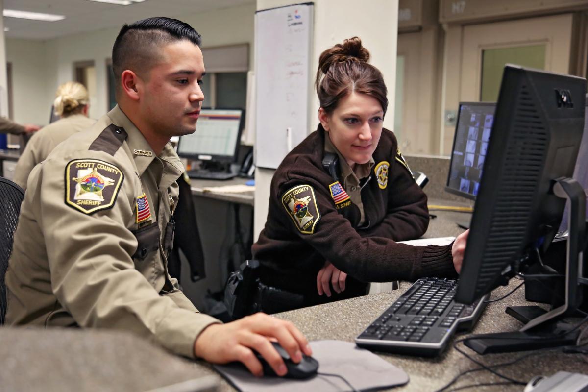 a man and woman officers working on a computer