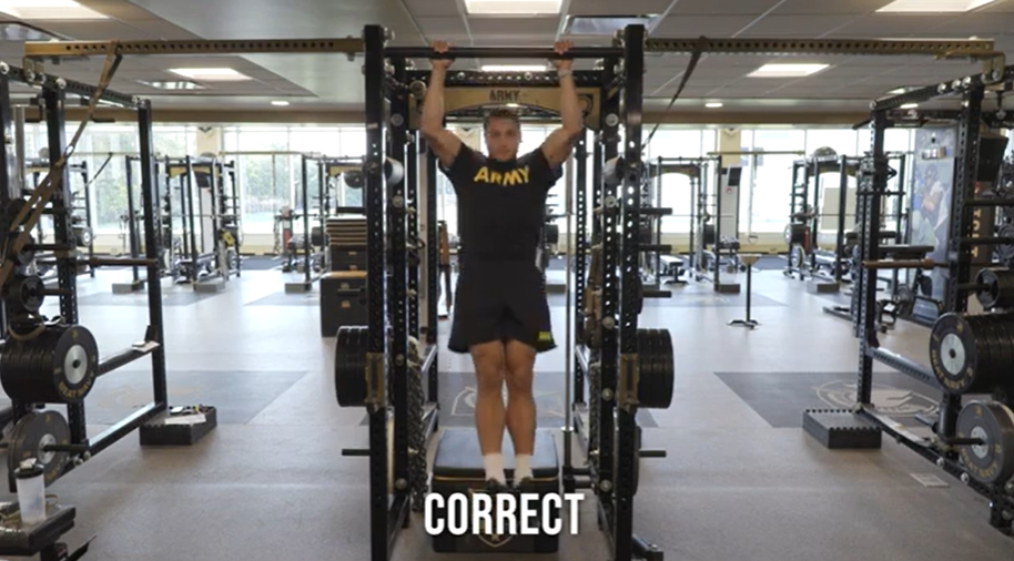 Man practices pull-ups.